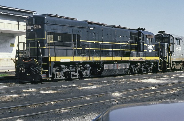 CSX - SCL ex GE U18B diesel locomotive # 1987 is seen on a track located next to the Uceta Shop building in the yard at Tampa, Florida, 1987