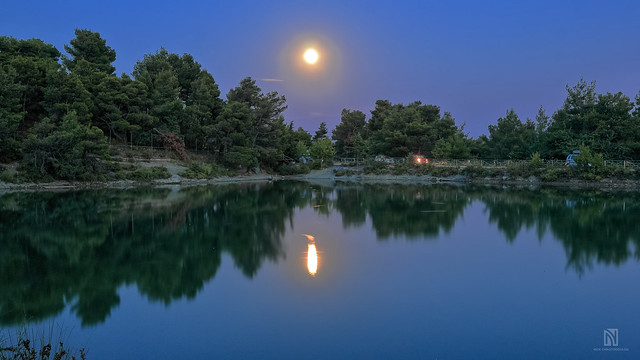 Moon over calm lake