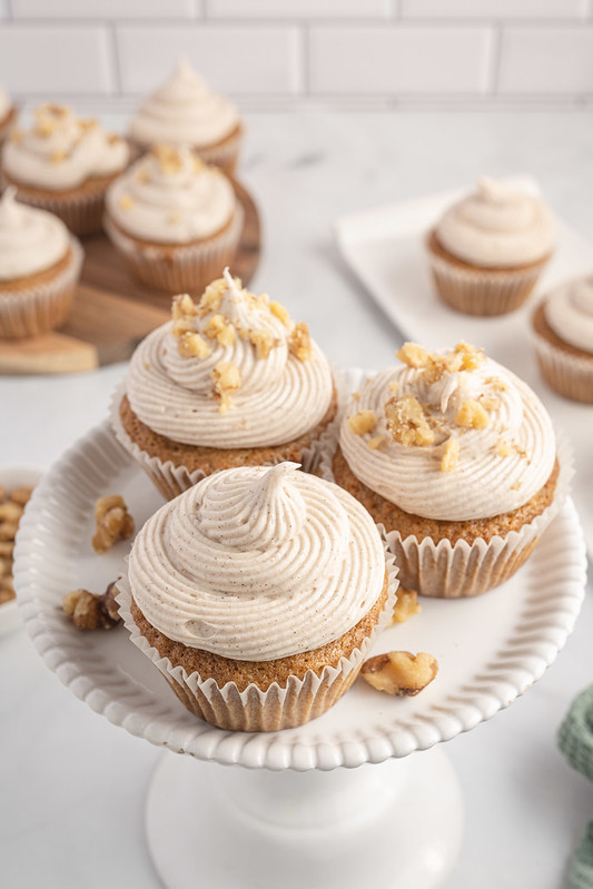 Carrot cake cupcakes with cream cheese frosting and walnuts on top