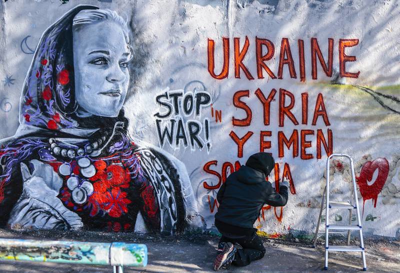哥倫比亞藝術家 Arte Vilu 的壁畫，呼籲停止在烏克蘭、敘利亞、葉門與索馬利亞的戰爭。（圖片來源：AP） 