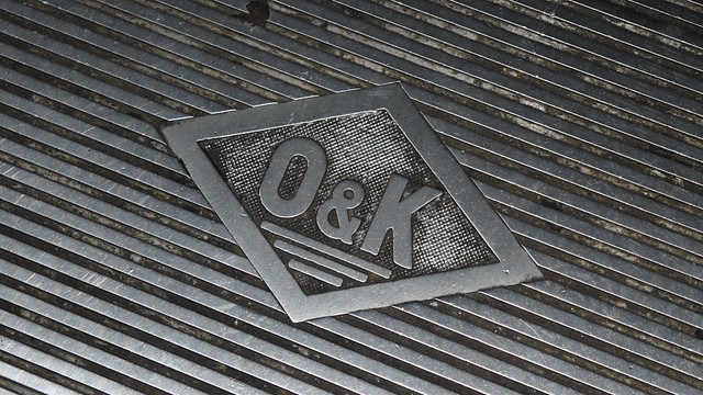 O&K logo on escalator landing