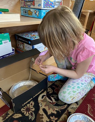 taping the gold coin to the inside of the lid so the box will close when the leprechaun climbs up to grab it, trapping him inside