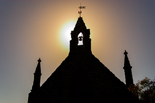 Silhouette of old church in Bulla Victoria with sun setting behind the bell tower