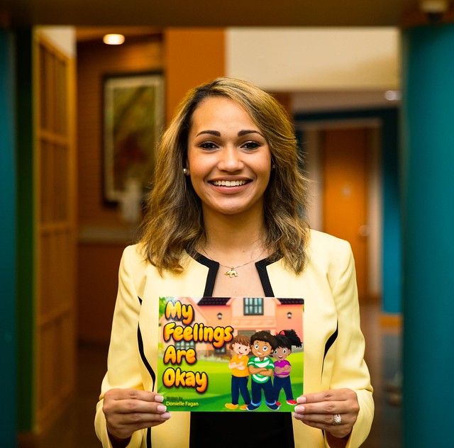 Donielle Fagan holds her children's book.