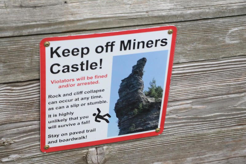 Warning sign at Miners Castle telling people to stay off the precipitous rocks