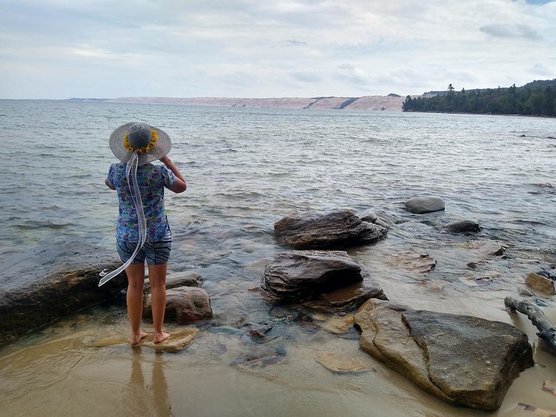 Vicki standing in Lake Superior as we look east toward the Grand Sable Sand Dunes in Pictured Rocks NL