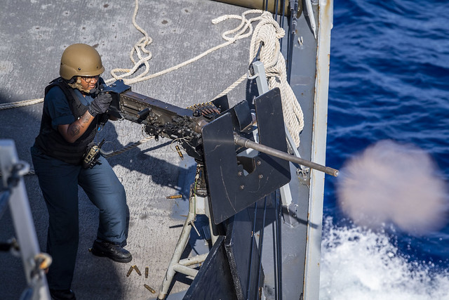 Gunner’s Mate Seaman Raquell Carson fires a .50-caliber machine gun during a live-fire exercise in the Philippine Sea.