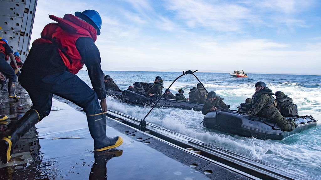 Sailors and Marines conduct combat rubber raiding craft training aboard USS Anchorage (LPD 23) in the Pacific Ocean.