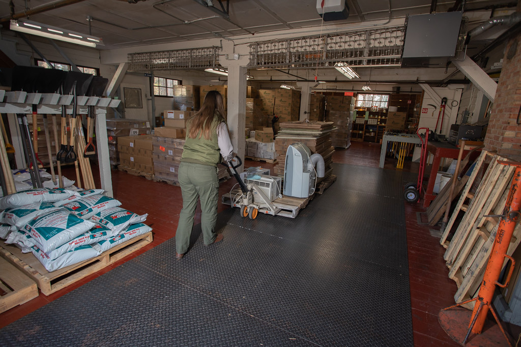 Pallet jack moving palletized goods in a warehouse