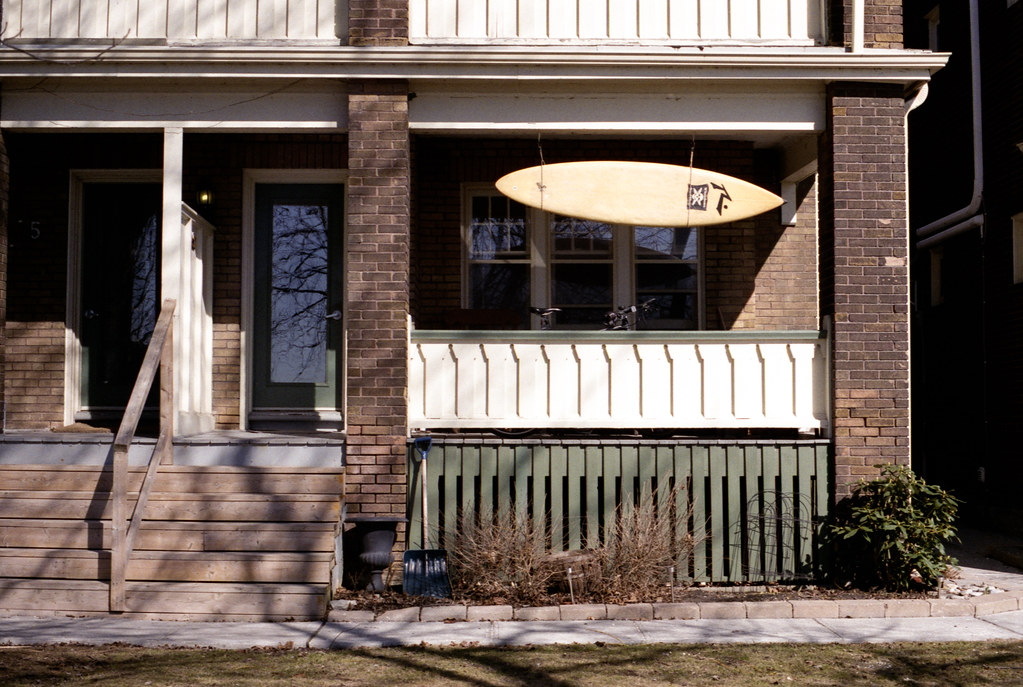 Wooden Surfboard Over the Porch