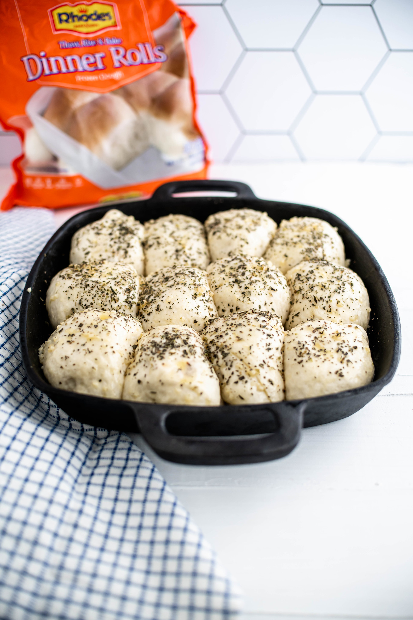 Risen rolls brushed with butter and sprinkled with Italian seasoning.