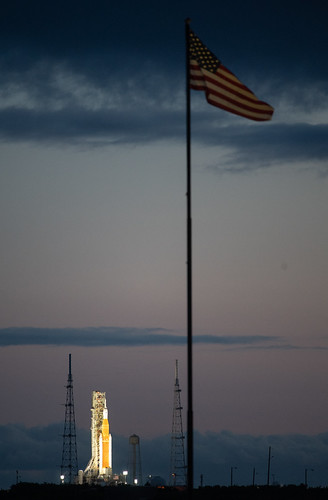 Artemis I Wet Dress Rehearsal (NHQ202204030003) by NASA HQ PHOTO, NASA’s Space Launch System (SLS) rocket with the Orion spacecraft aboard is seen at sunrise atop a m