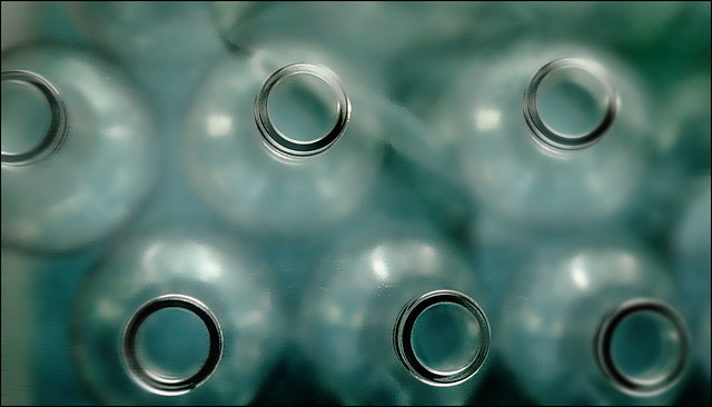 six bottles under a transparent layer of shrink film