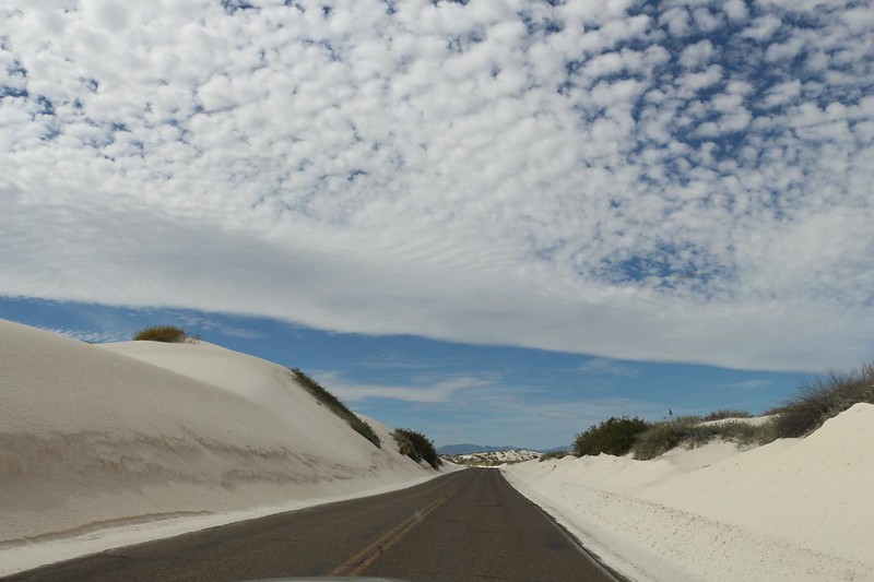 The white sand dunes constantly attempt to overrun the road at White Sands National Park