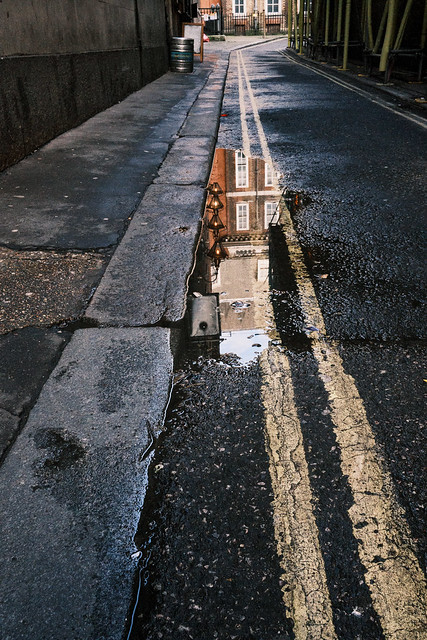 Reflection in a puddle of water - Craig's Ct, London