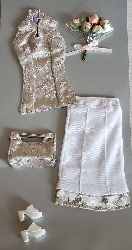 This outfit came in two versions for the shades of the flowers in the pattern and the flowers.  A rose pink and a lavender.  This appears to be the pink.