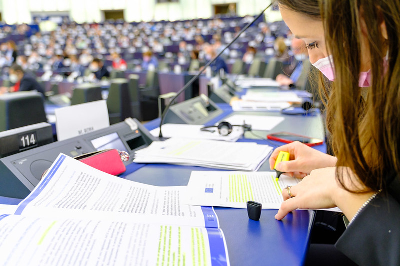 A participant takes notes during a session of the Conference on the Future of Europe in the plenary hall of the European Parliament