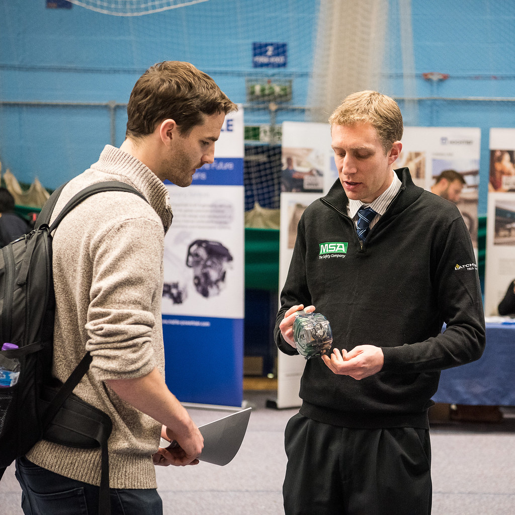 A student meeting an employer at a careers fair.