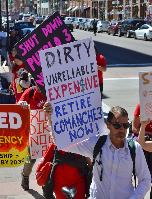 Protesters marched through downtown Denver to call on Xcel Energy to shut down coal fueled power plants.
