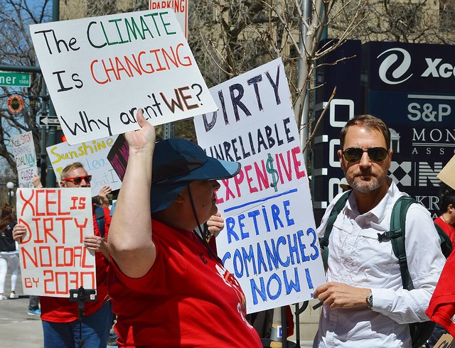 The role of coal in creating the climate change was on minds of protesters outside Xcel Energy's Denver office.