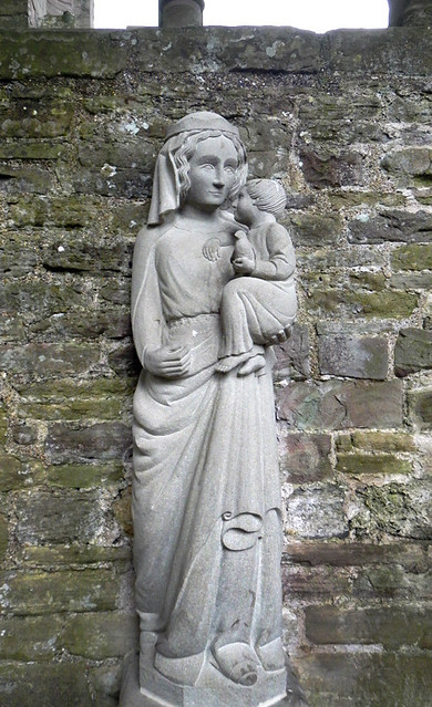 Statue of Mary and baby Jesus amidst the ruins at Tintern Abbey in Wales