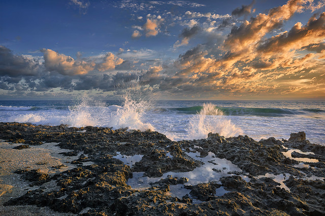 Waves splashing over the reef at Bathtub Reef Beach at sunrise on Hutchinson Island, Florida