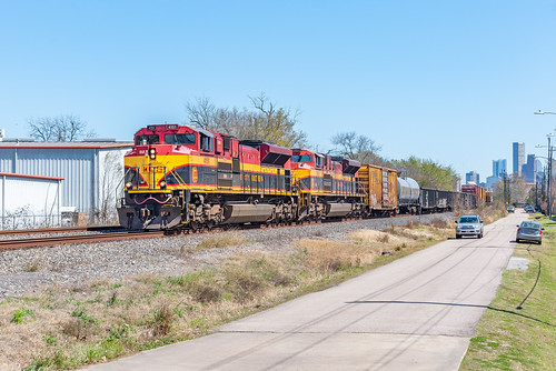 Bayou City Belles by Christopher Parma, With a sliver of the skyline visible in the distance, KCS 4151 rolls westward from Texas's largest c