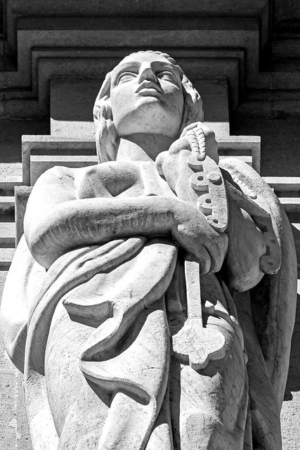 Look Up - A Stone Figure -The  Front of Valencia Town - City Hall (Plaza Ayuntamiento) (Monochrome)  (OMDS - OM1 & OM 40-150mm f4 Pro Zoom)