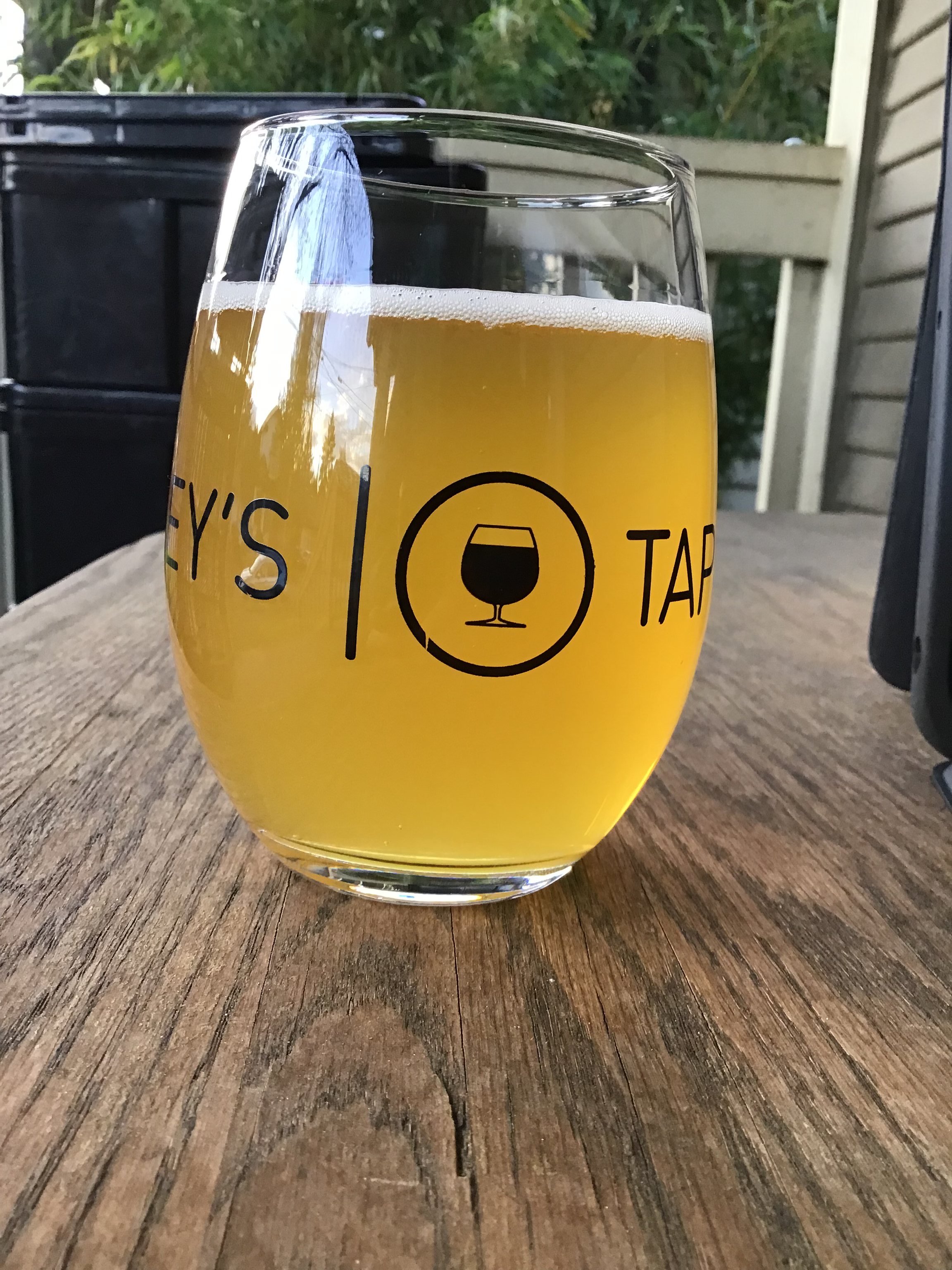 Brick West Brewing's Out Cold IPA in a glass on a table outside