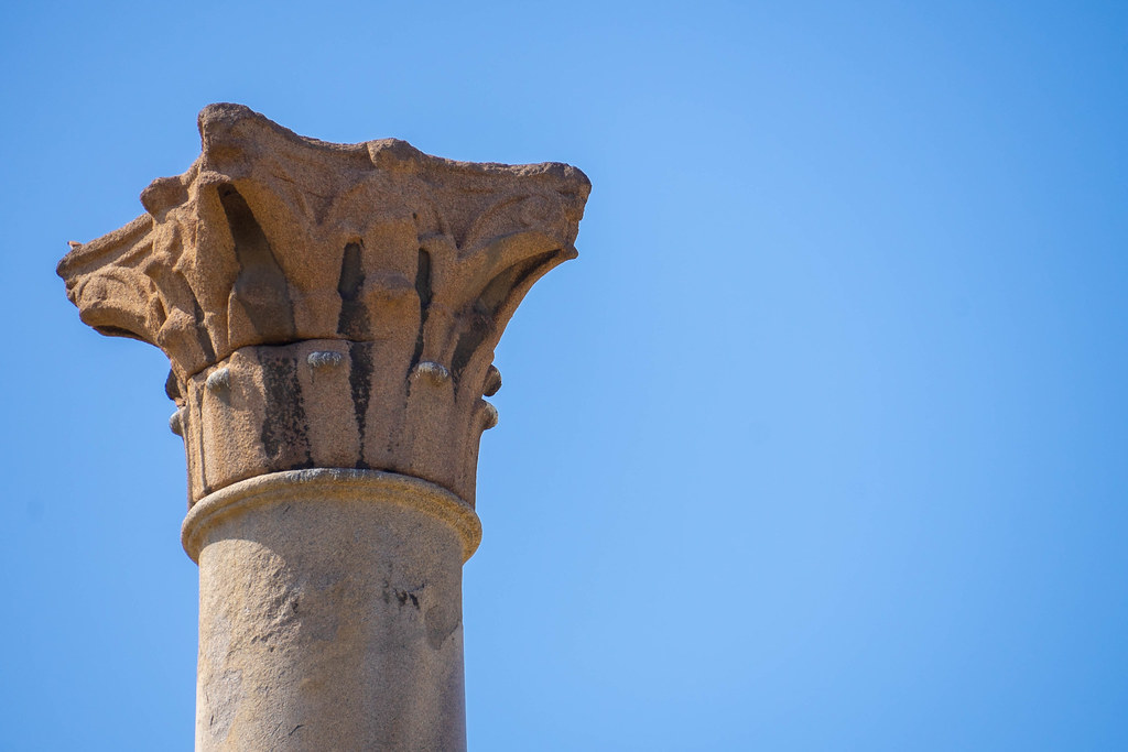 A close-up of the top of the pillar, with its capitol in prim plan.