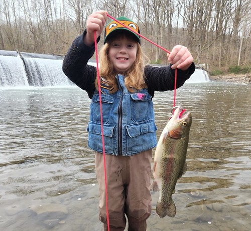 Photo of girl with large fish on a line