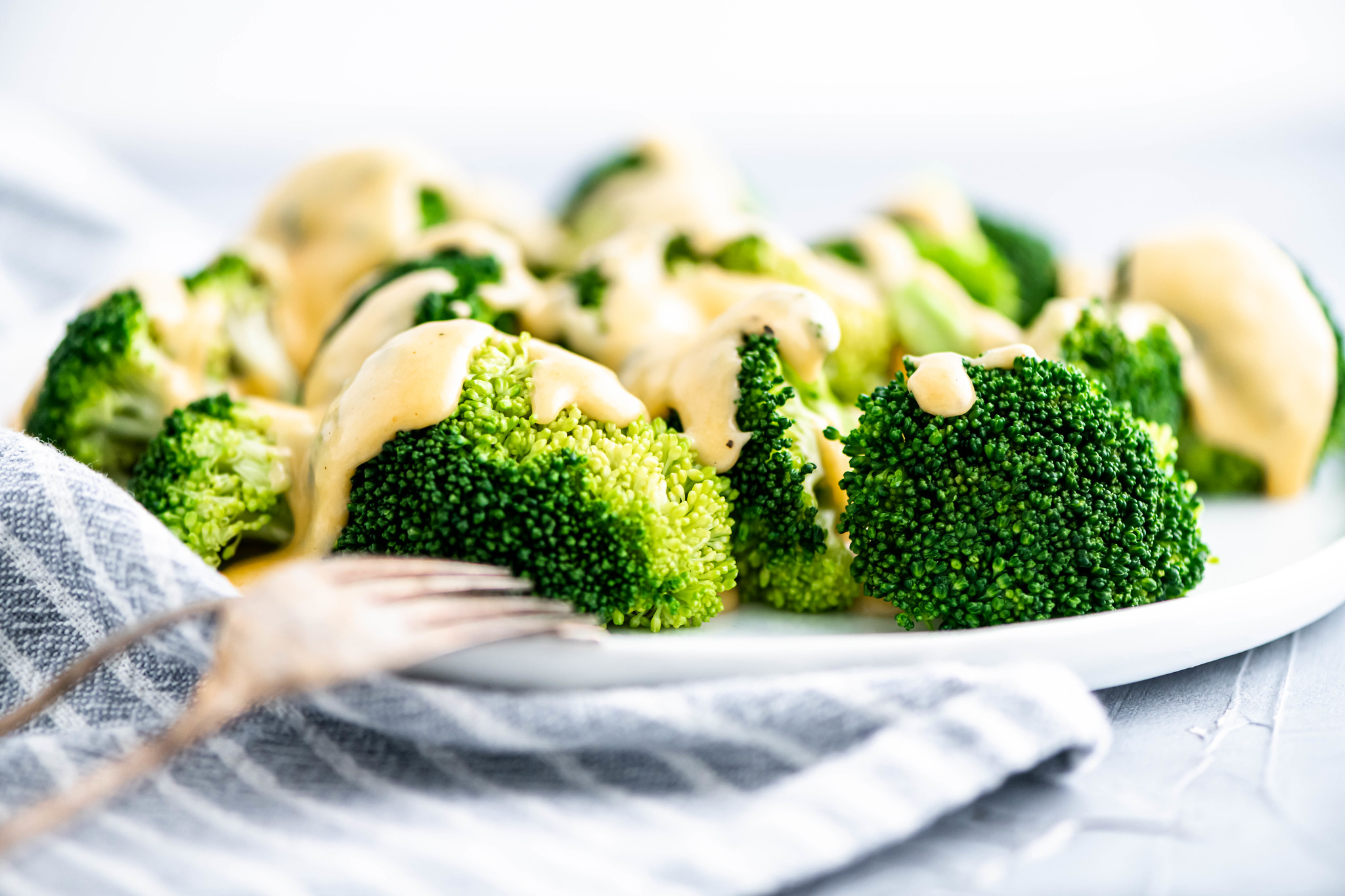Fresh steamed broccoli with cheese sauce.