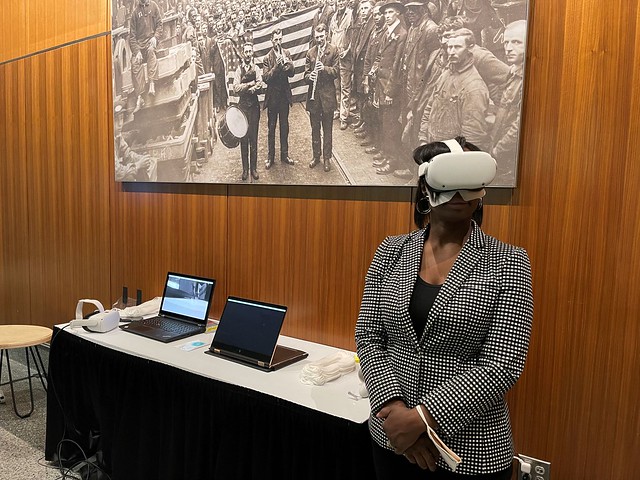 Tracie Todd uses virtual reality at a research exhibit.