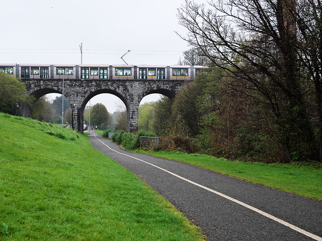 Southbound Luas passes over the Nine Arches Bridge, Milltown
