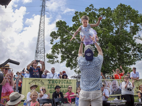 A young audience member flies high during French Quarter Fest 2022. Photo by Marc PoKempner.