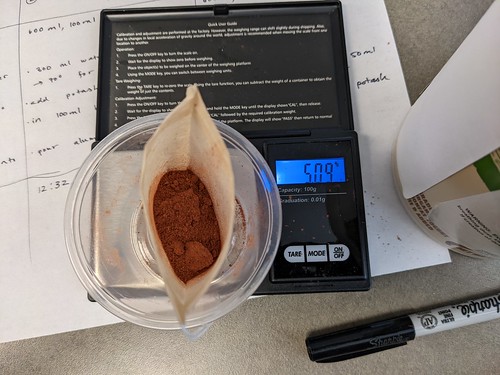Ground powder in bag on scale that reads 501g