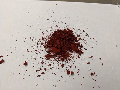 Reddish pigment from filter is removed and now on paper