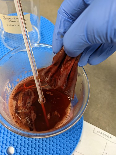 Hand removes drawstring bag from Standard Alum Extrc 3 beaker