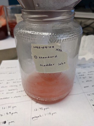 Reddish liquid drained through filter into Standard Madder Lake jar