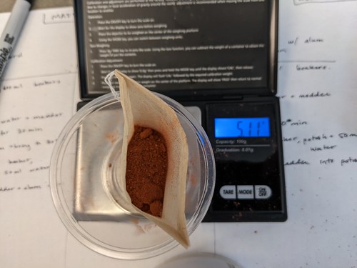 Ground powder in bag on scale that reads 511g