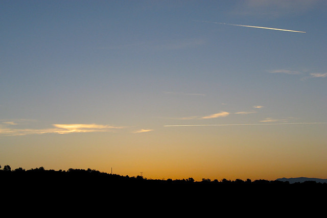 Sunrise with aircraft vapour trails