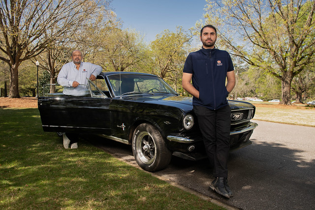 Muhammad Ajmal Khan, and his son, Abdul Rehman pose with a ’66 Mustang they restored together