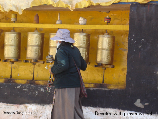 A devotee with a prayer wheel