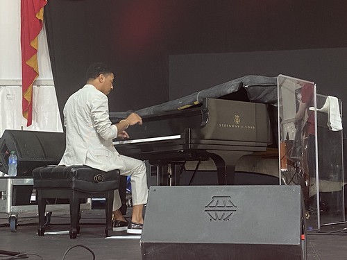 Christian Sands of Newport All-Stars honor George Wein in the WWOZ Jazz Tent at Jazz Fest on May 6, 2022. Photo by Carrie Booher.