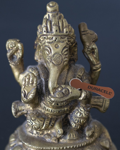 Ganesh holding a tiny battery
