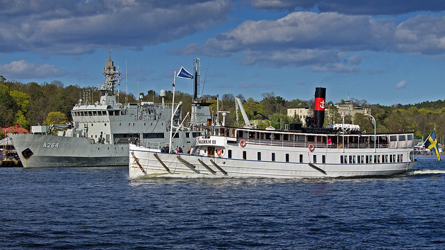 The archipelago ship Waxholm III in Stockholm, passing by the HMS Trossö