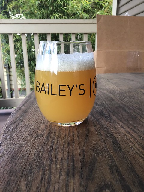 Tunnel Vision hazy IPA by Bearded Iris brewing in a glass outside on a table.