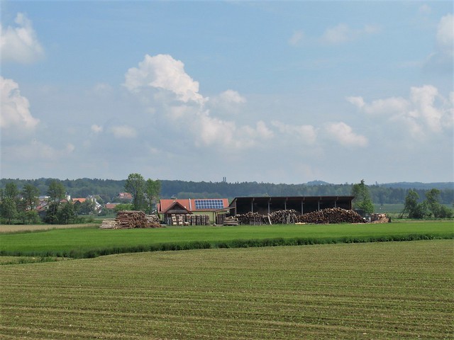 Lumber and solar panels, view across a field near Walkersdorf, Austria