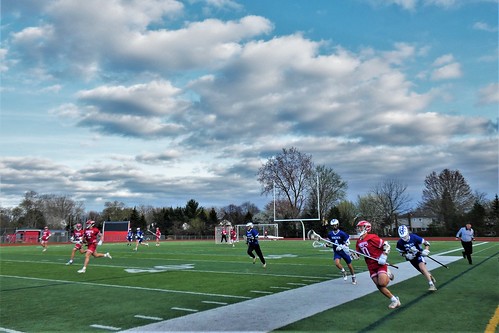 sport lacrosse game field sky clouds landscape scenery outside outdoors people boys may spring green blue red