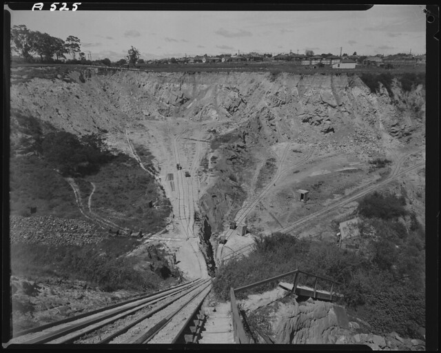 View looking down into clay pit with two workers pushing a trolley at base, Oakleigh Brick Works, Stamford Road, Oakleigh, undated
